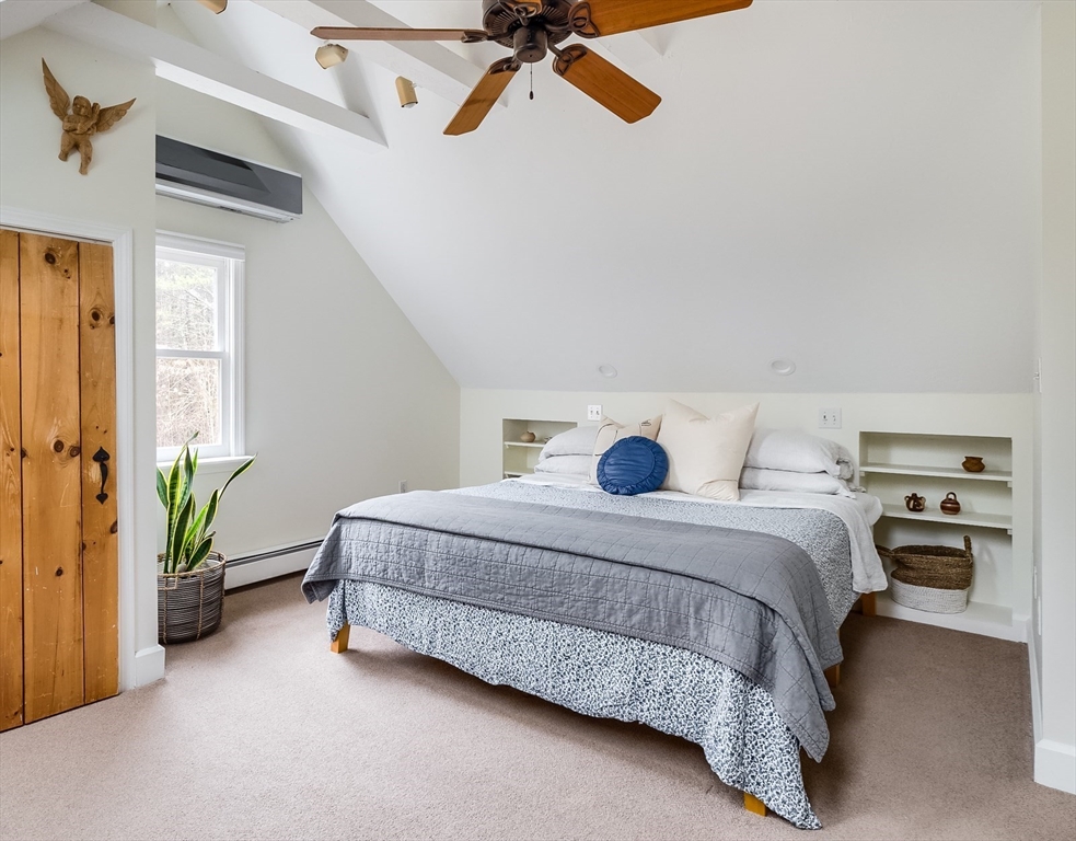 183 Sterling Road Princeton, MA 01541 - Photo 17 of 35 a spacious bedroom with a bed and a chandelier