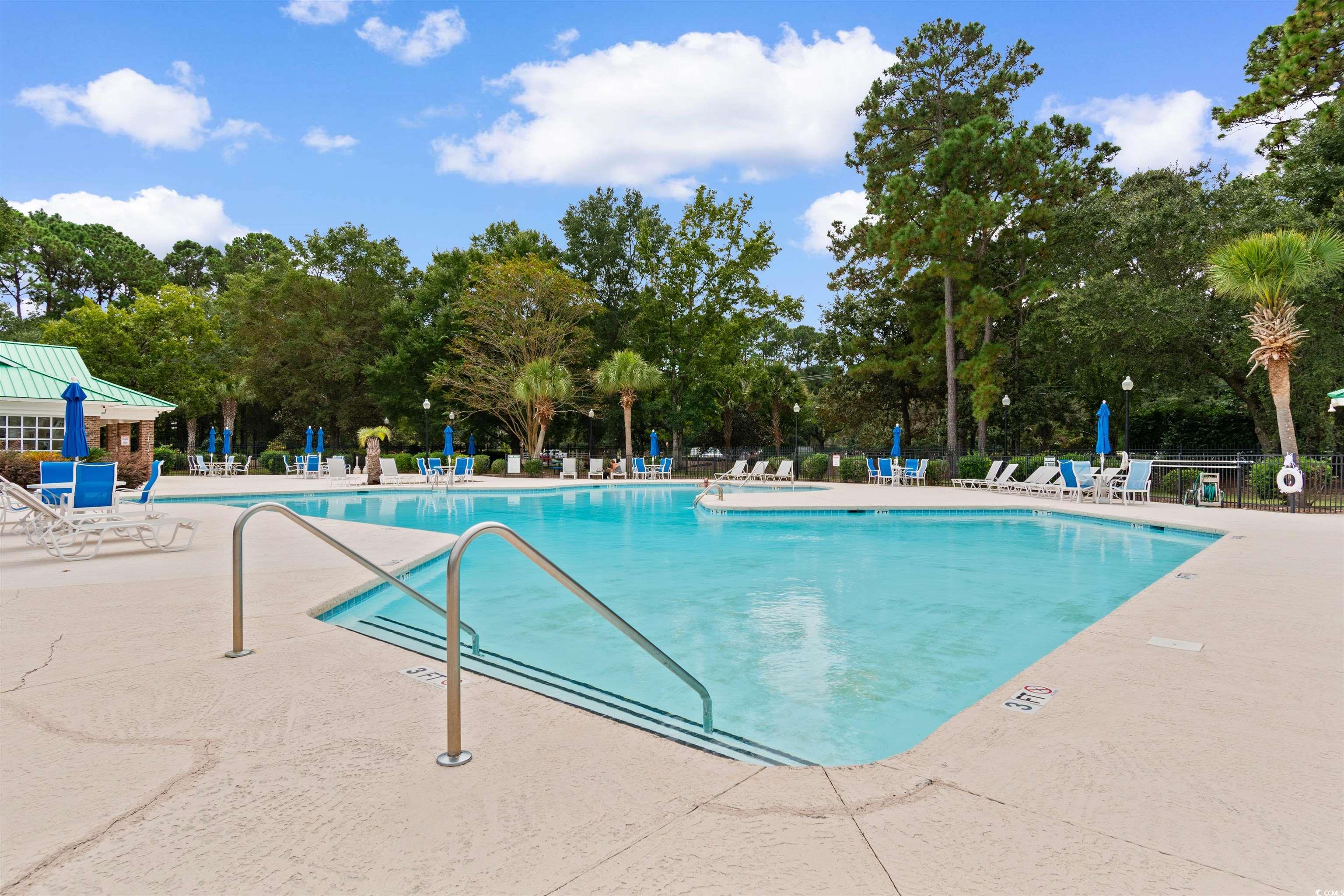 4430 Lady Banks Lane, Unit A2 Murrells Inlet, SC 29576 - Photo 26 of 31 Community pool featuring a patio area and view of scattered trees