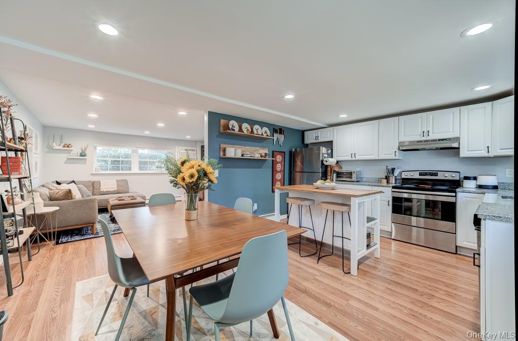 4 Forge Gate Drive, Unit F3 Cold Spring, NY 10516 - Photo 11 of 20 a kitchen with stainless steel appliances kitchen island granite countertop a table chairs and a refrigerator
