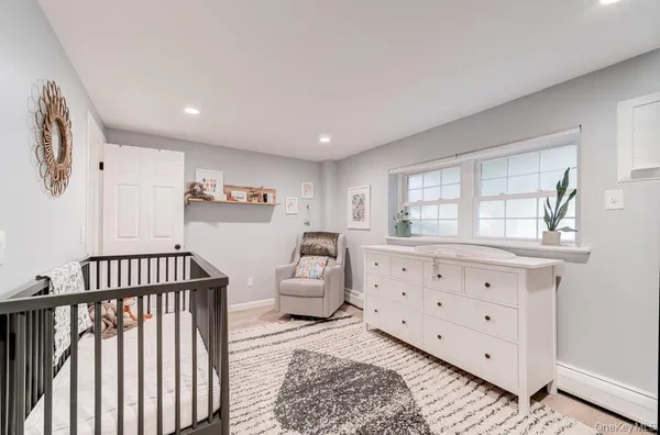 a bedroom with furniture and a window