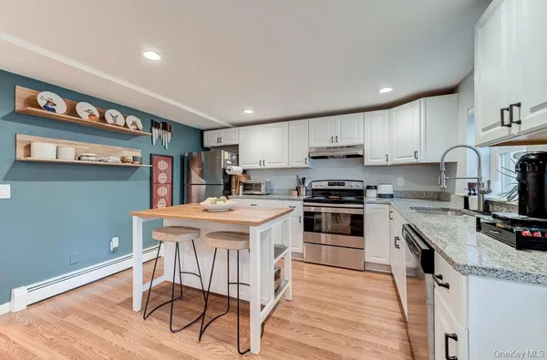 a kitchen with a stove a sink and a refrigerator