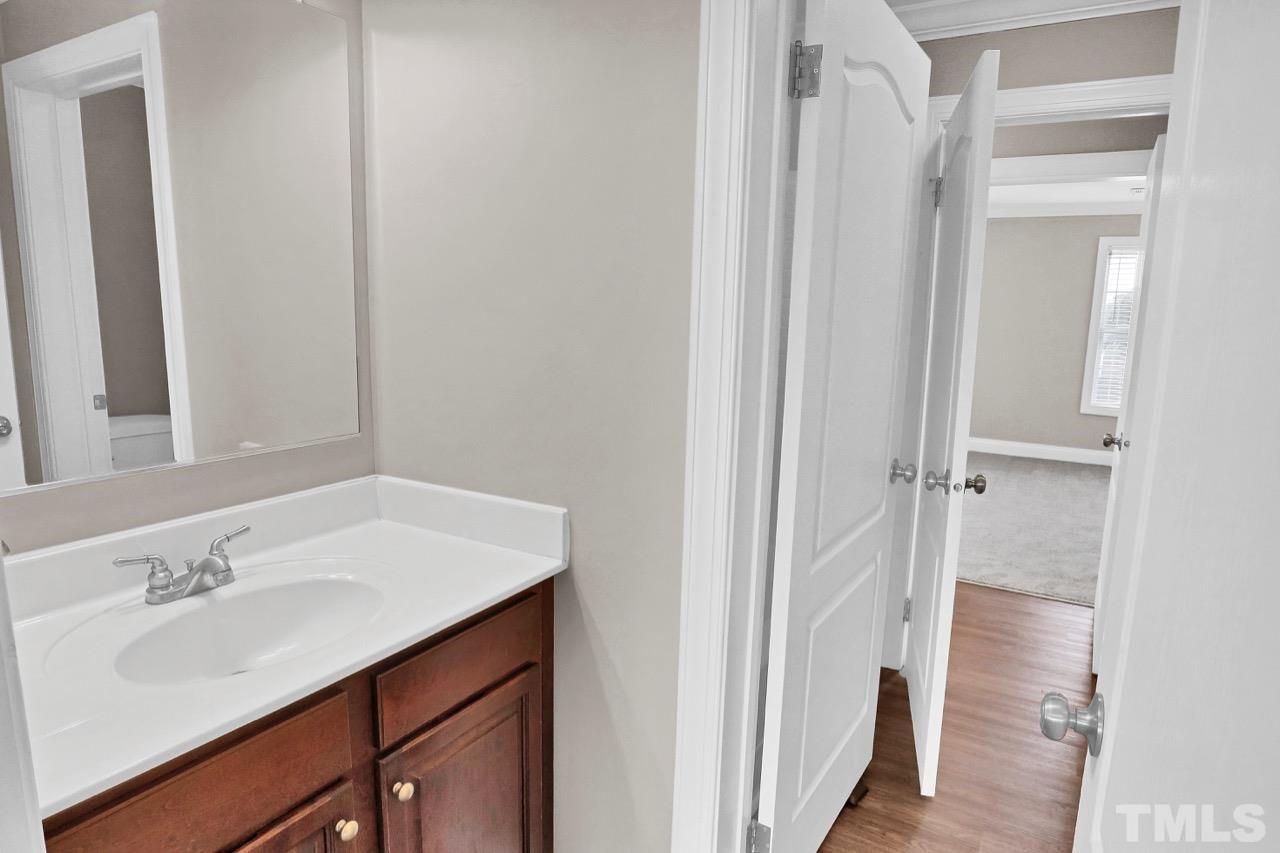 1209 Silver Farm Road Raleigh, NC 27603 - Photo 22 of 30 a bathroom with a sink and a mirror