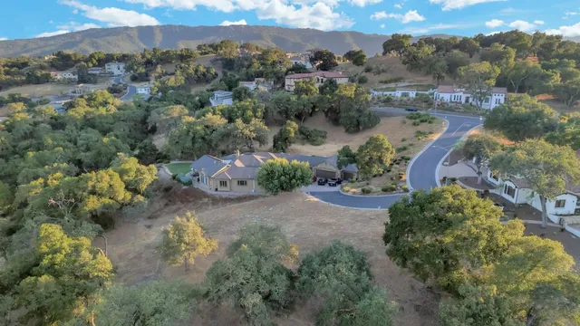 an aerial view of a house with a yard and lake view