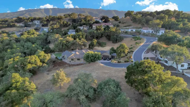 an aerial view of a houses with a yard