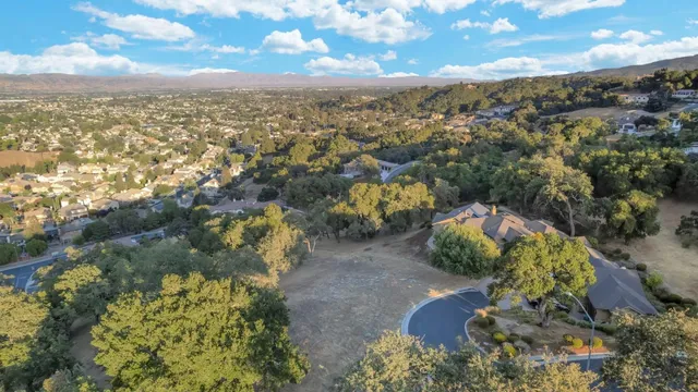 an aerial view of a houses with a yard