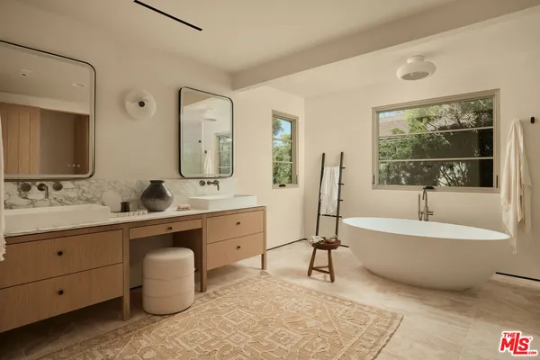 a bathroom with a double vanity sink and a mirror