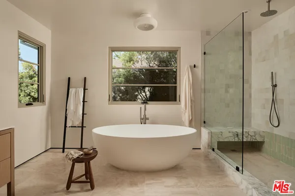 a bathroom with a bathtub and shower