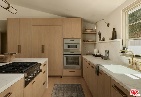 a kitchen with a sink stove and cabinets