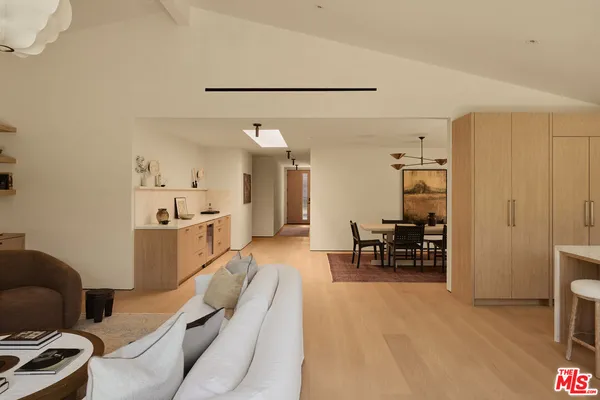 a living room with furniture and a dining table