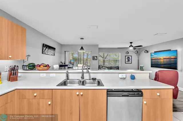a kitchen with stainless steel appliances granite countertop a refrigerator and a cabinets
