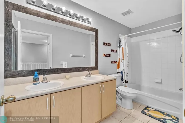 a bathroom with a sink double vanity and a toilet