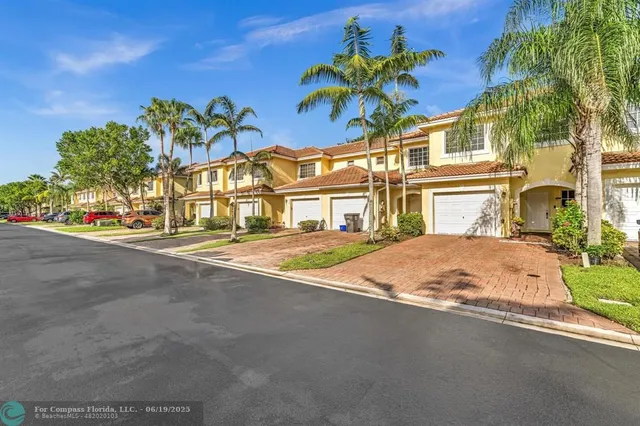 a front view of a house with a yard and a garage