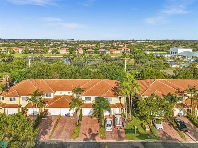 an aerial view of residential building with green space