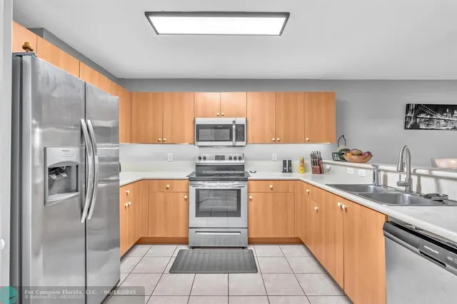 a kitchen with stainless steel appliances granite countertop a sink stove and microwave