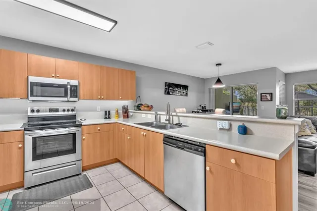 a kitchen with stainless steel appliances granite countertop a sink and cabinets