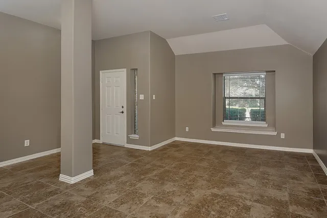 an empty room with windows and closet