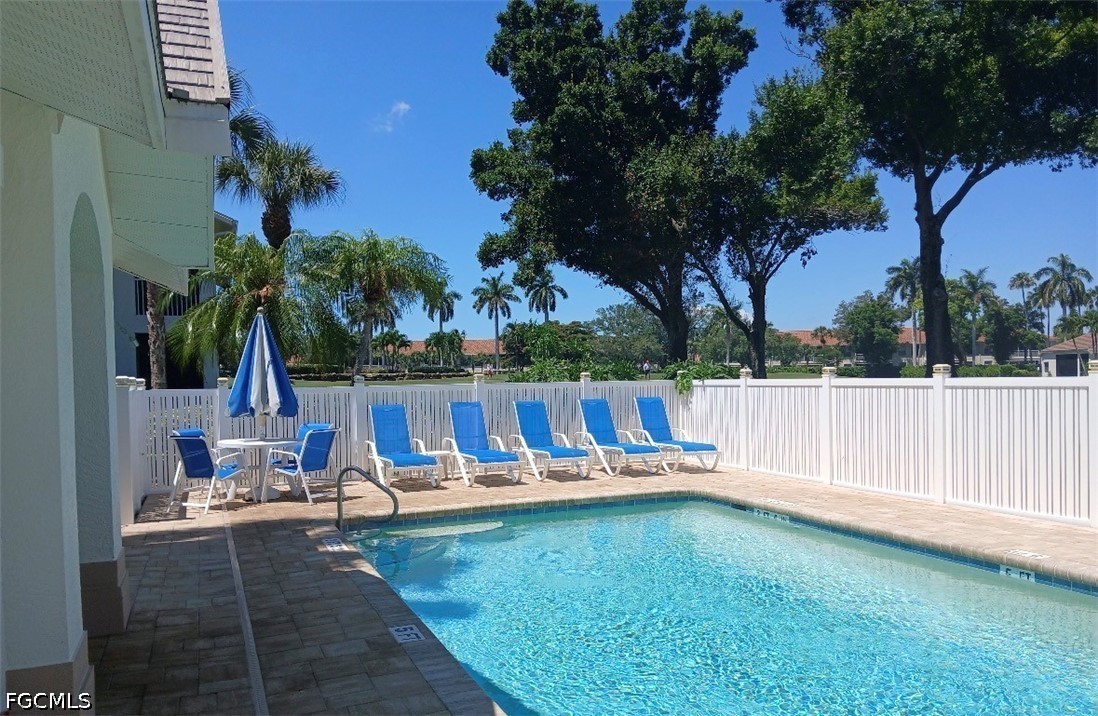 14971 Rivers Edge Court, Unit 101 Fort Myers, FL 33908 - Photo 14 of 15 swimming pool view with a garden
