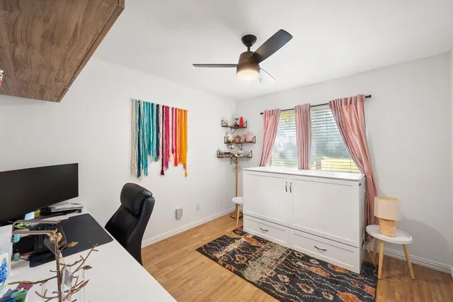 a view of workspace with wooden floor windows