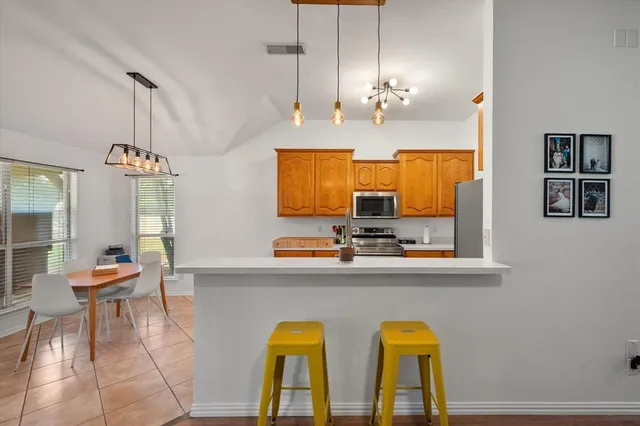 a view of a dining room with furniture and chandelier