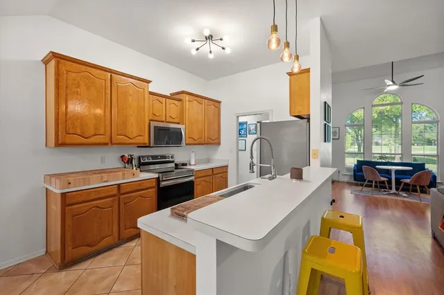 a kitchen that has a sink and a stove in it