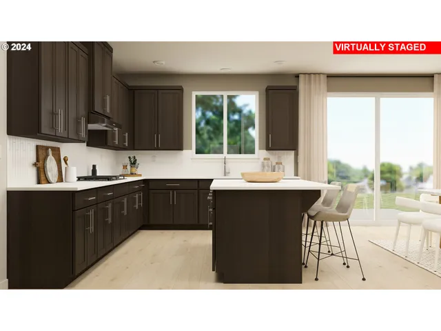 a kitchen with a sink cabinets and wooden floor