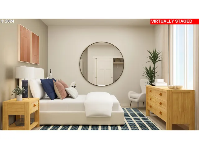 a living room with a mirror and a potted plant