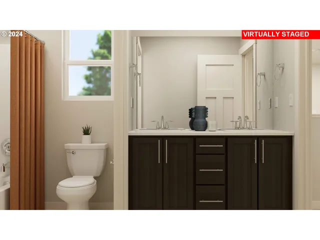 a bathroom with a black countertop sink toilet and mirror