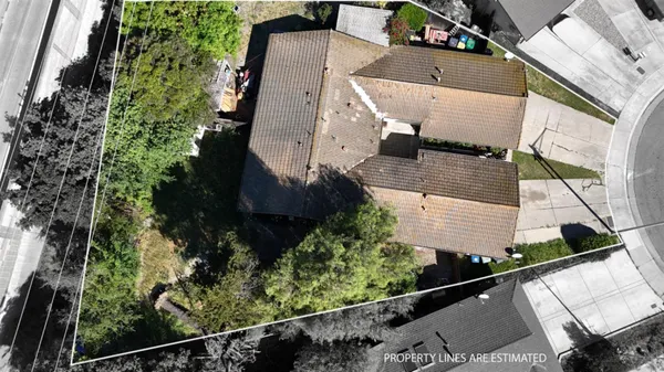 an aerial view of a house with a yard