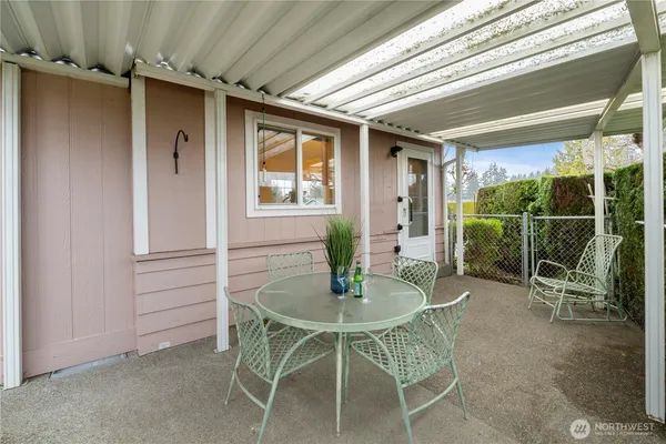 a view of a patio with table and chairs