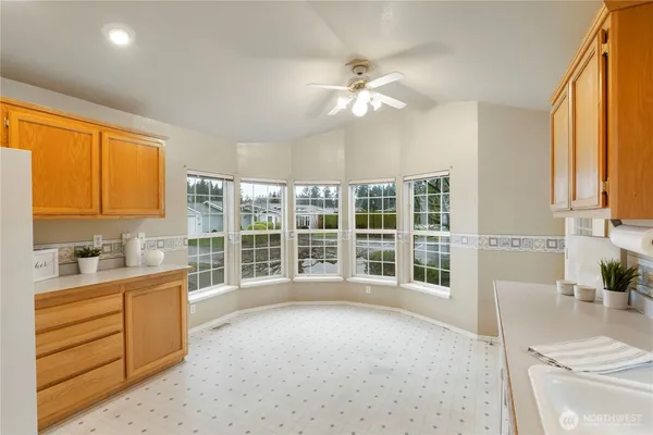 a view of a kitchen with a sink and dishwasher with wooden floor