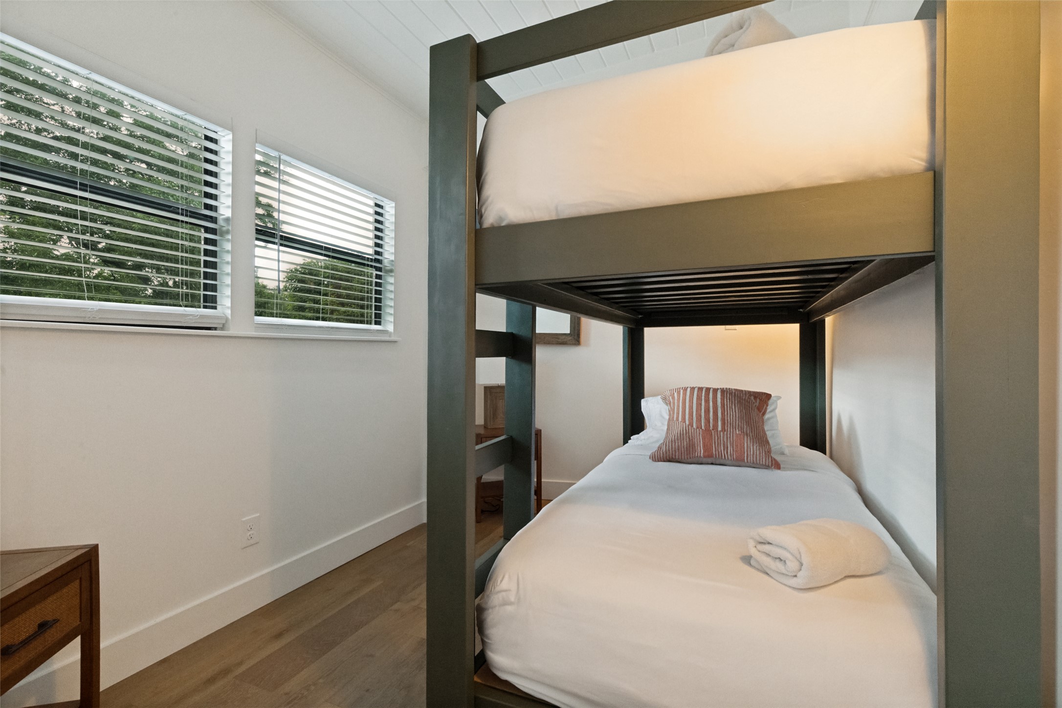 303 Lago Verde Road Austin, TX 78734 - Photo 6 of 39 Two bright windows illuminate a cozy bedroom featuring a sturdy bunk bed frame.