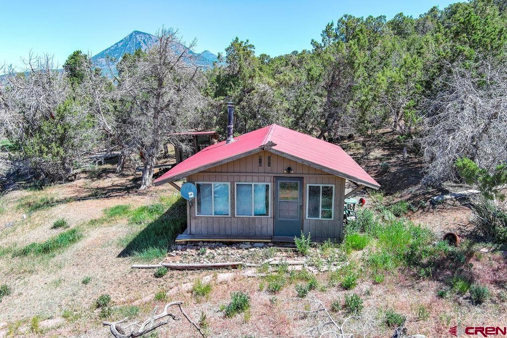 42415 Piburn Flats Road Crawford, CO 81415 - Photo 4 of 19 a front view of a house with a yard