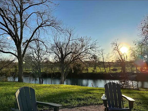 a view of a lake with a table and chairs