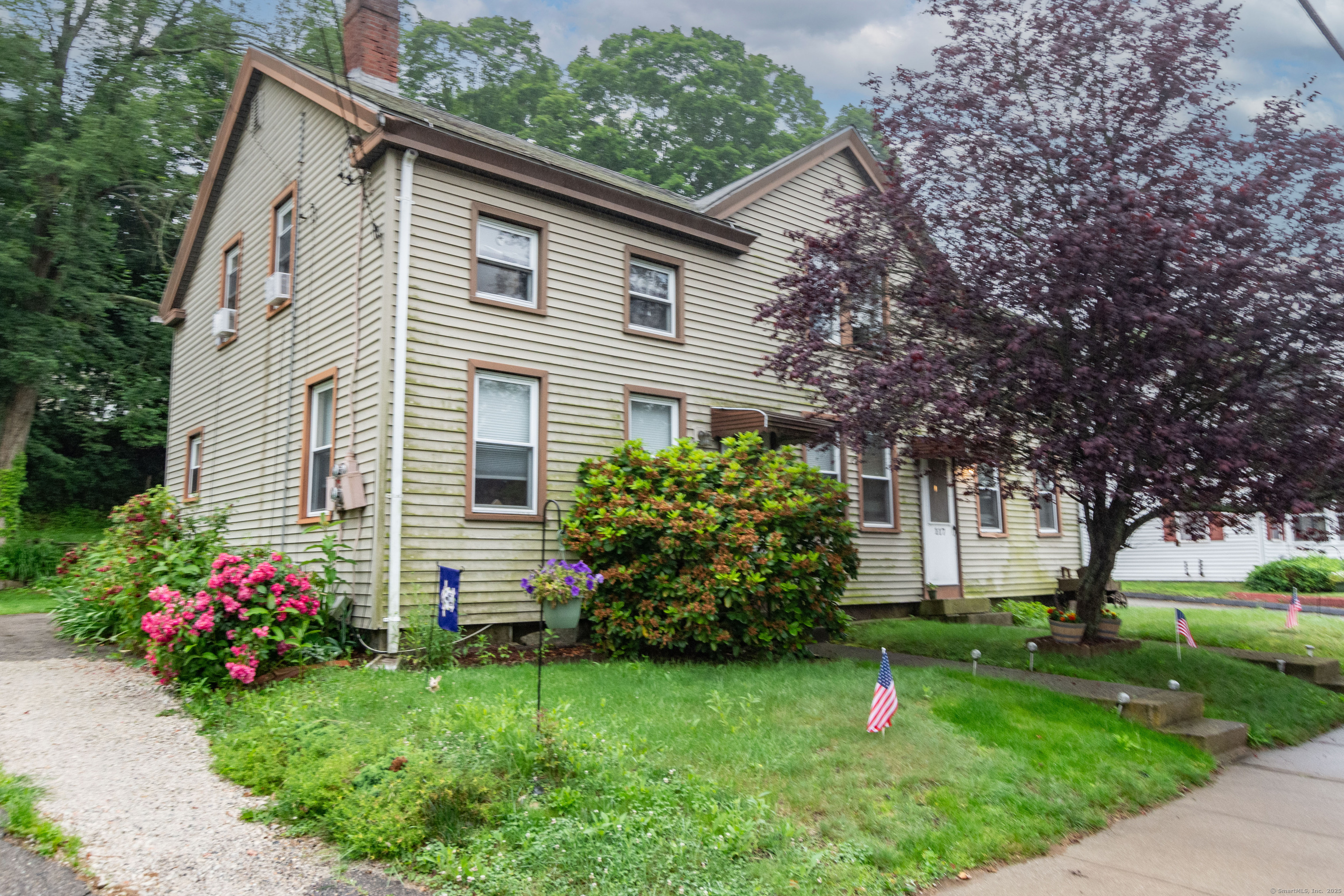 a front view of a house with a garden