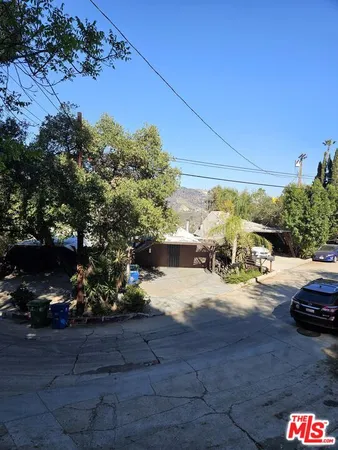 a view of a street with cars parked