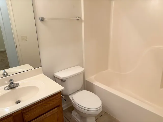 a white toilet sitting next to a bathroom sink