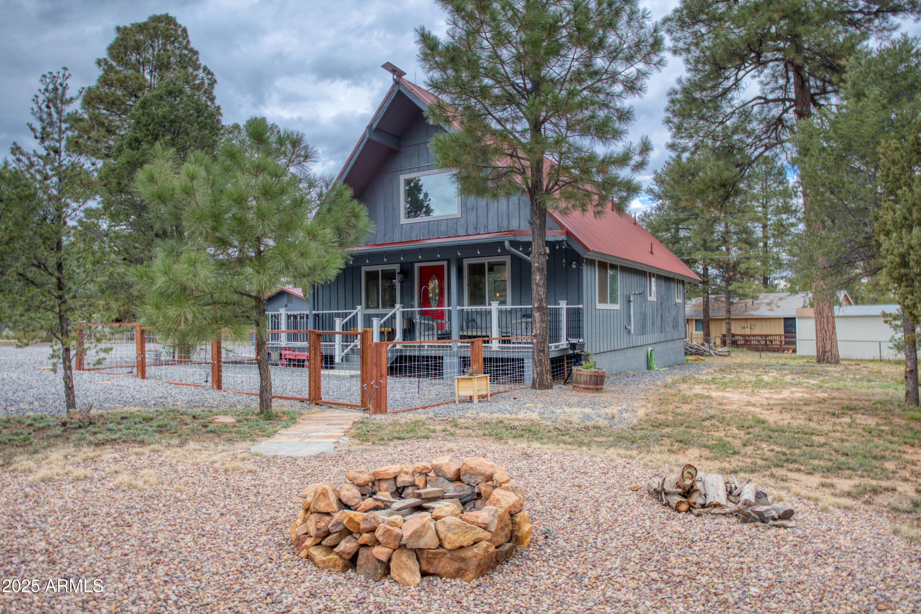 a view of a house with a yard siting area and tree