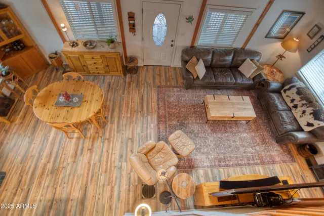 a living room with furniture a flat screen tv and kitchen view