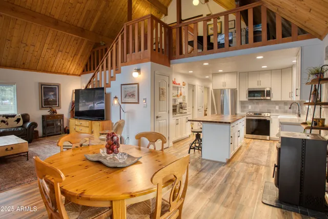 a kitchen with stainless steel appliances a refrigerator a stove a sink dishwasher and a oven with wooden floor