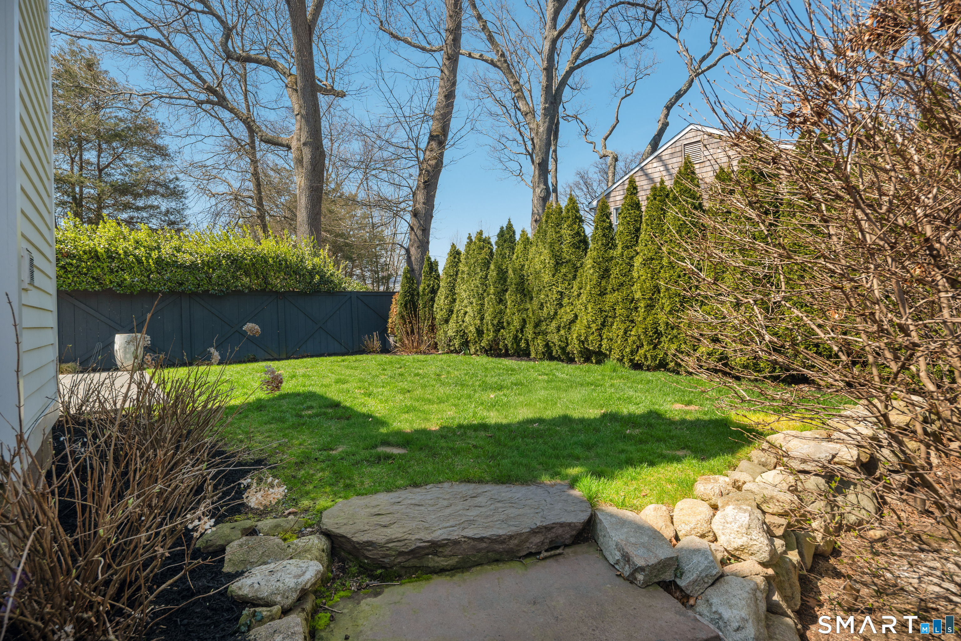 22 Craw Avenue Norwalk, CT 06853 - Photo 38 of 40 a view of a yard with an tree and a bench