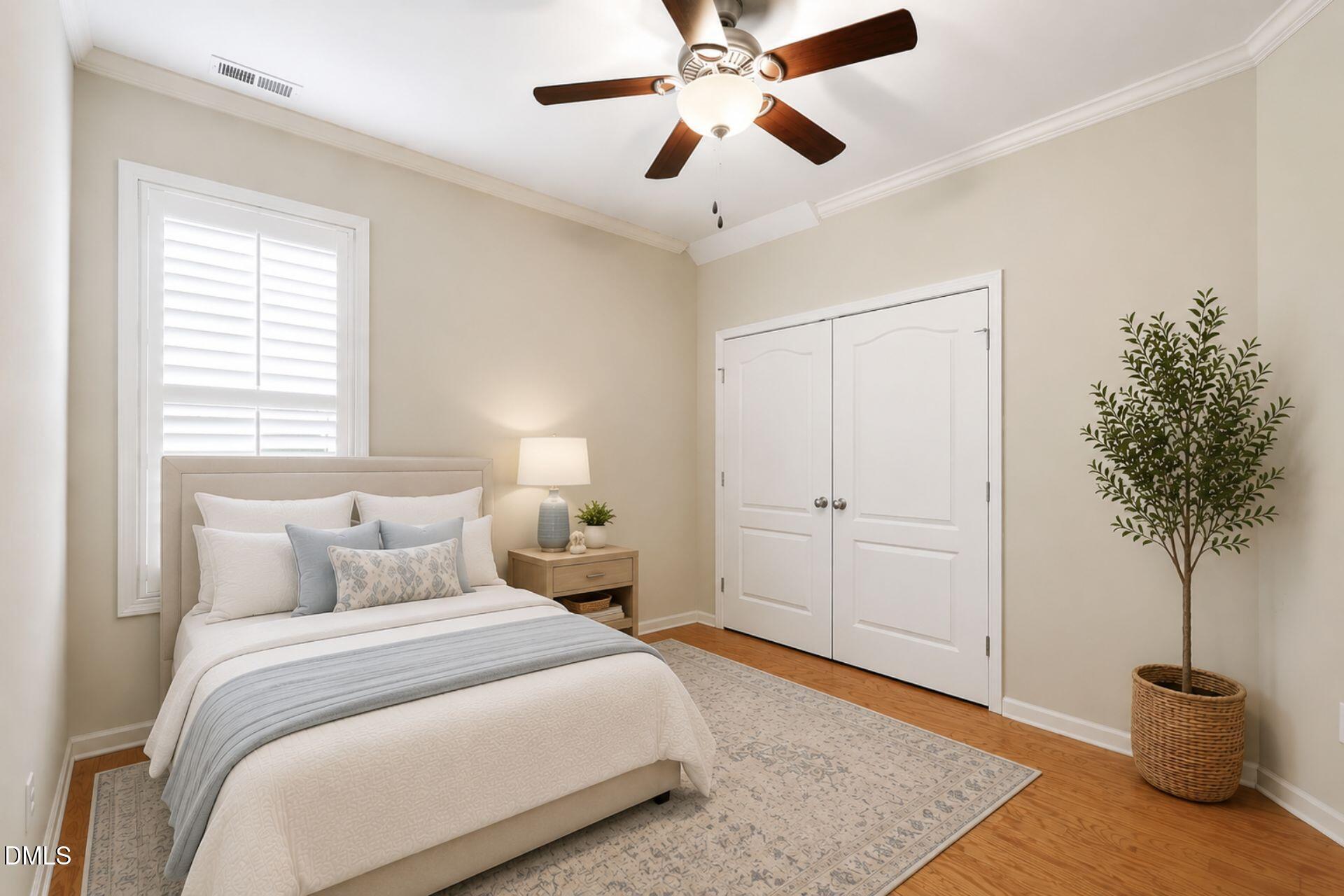 522 Brunello Drive Wake Forest, NC 27587 - Photo 10 of 24 a bedroom with a bed and a potted plant
