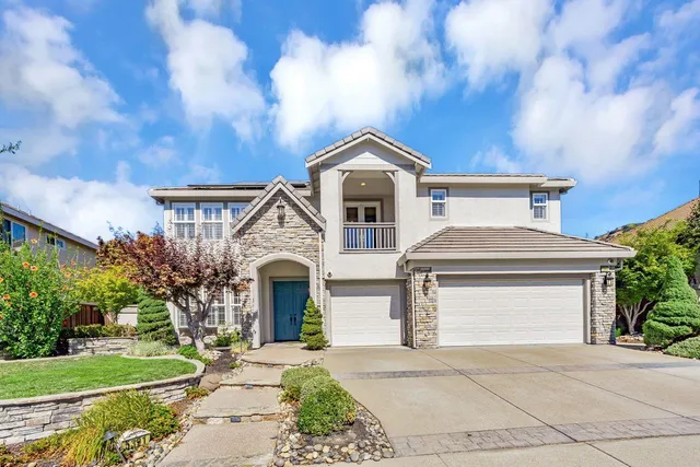 a front view of a house with a garden