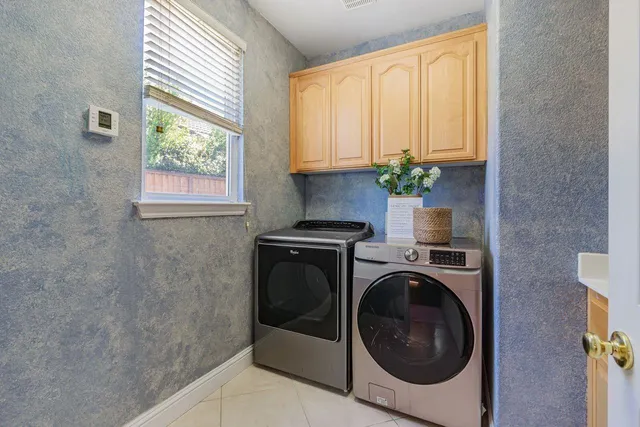 a utility room with sink dryer and washer