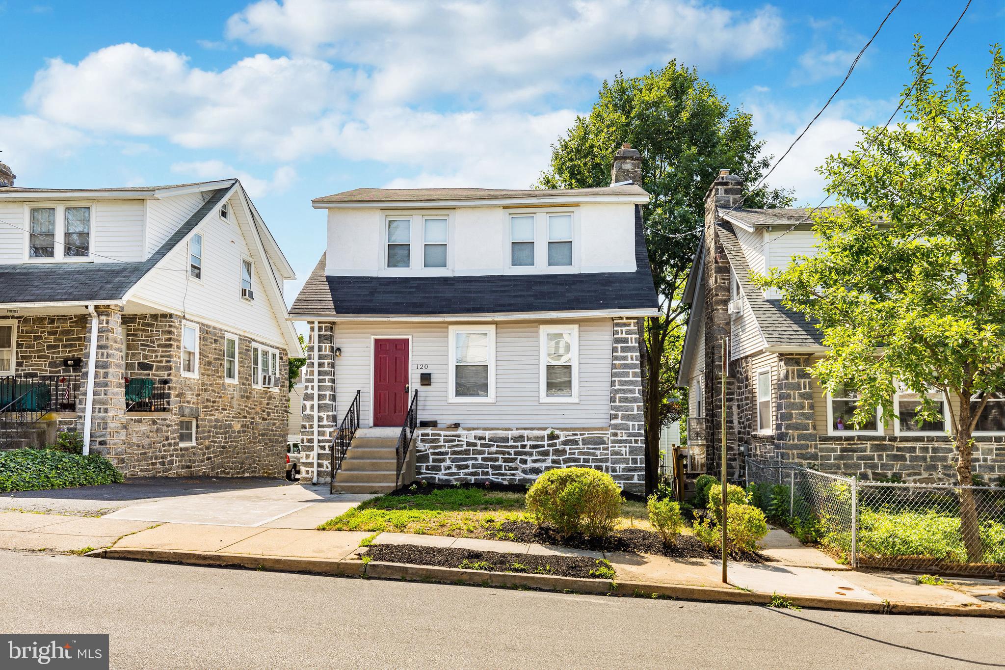 120 Englewood Road Upper Darby, PA 19082 - Photo 1 of 29 a view of a brick house with a patio and a yard