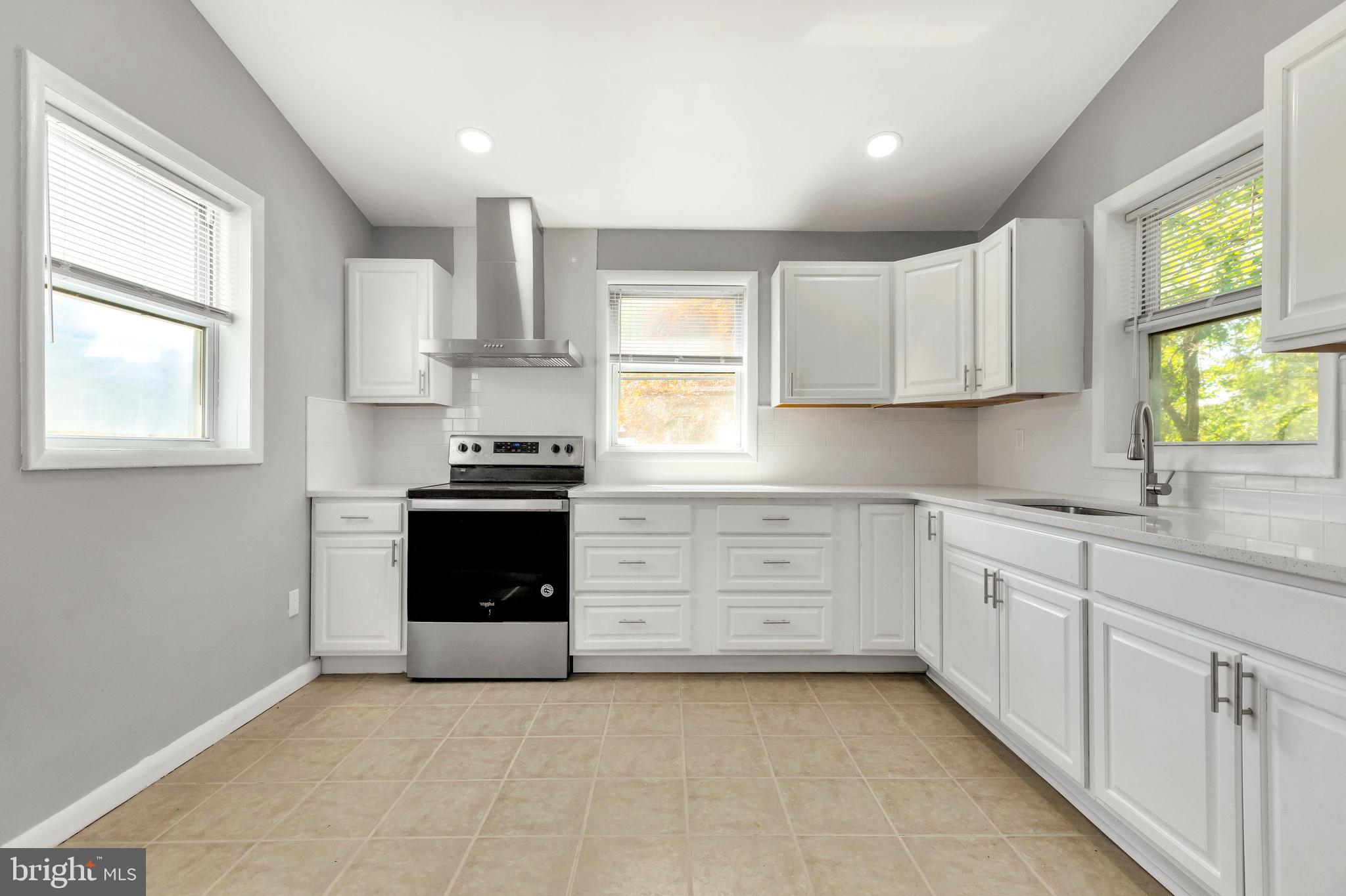 120 Englewood Road Upper Darby, PA 19082 - Photo 12 of 29 a kitchen with a white cabinets and a stove top oven