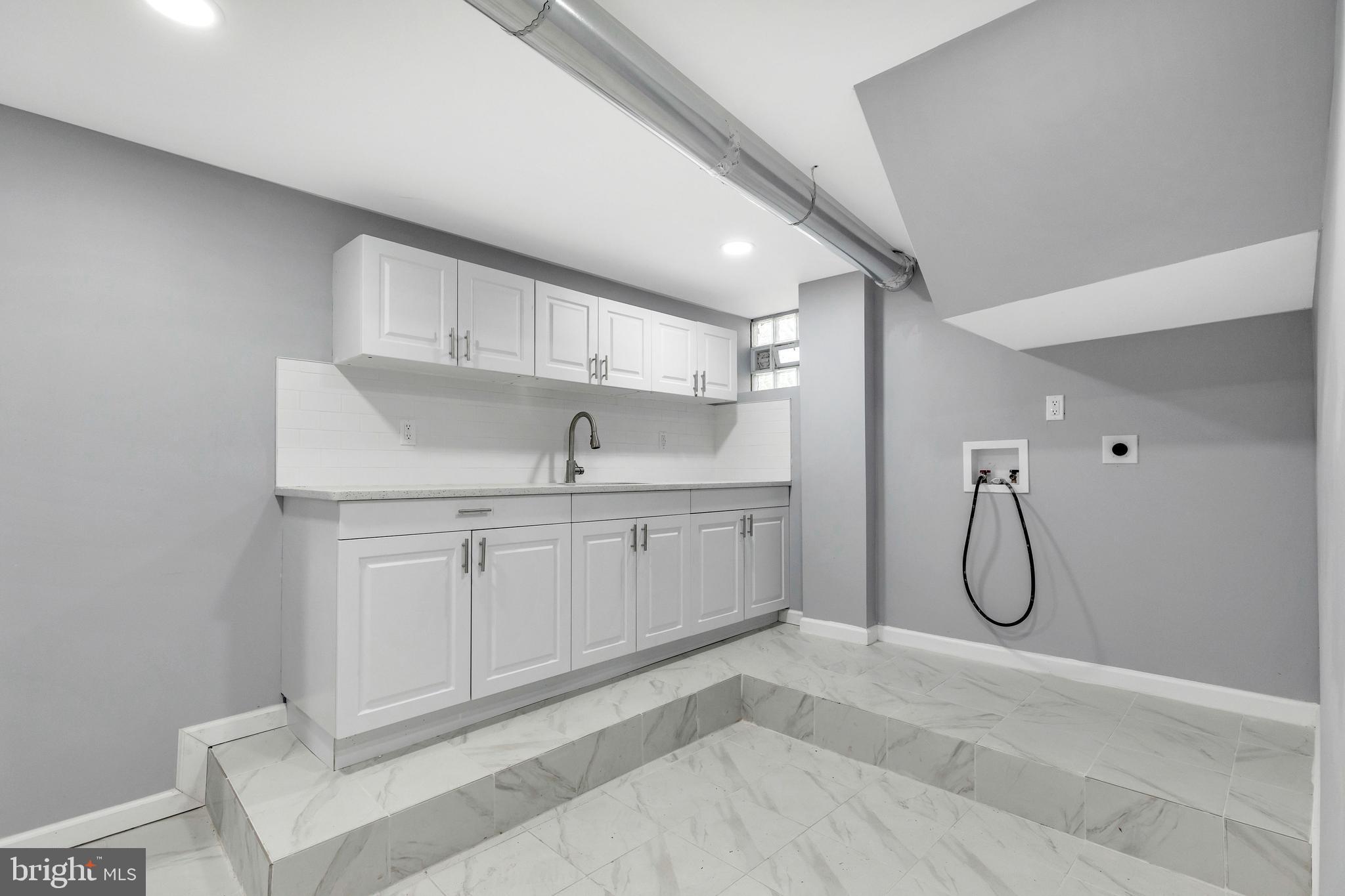 120 Englewood Road Upper Darby, PA 19082 - Photo 23 of 29 a room with white cabinets and window