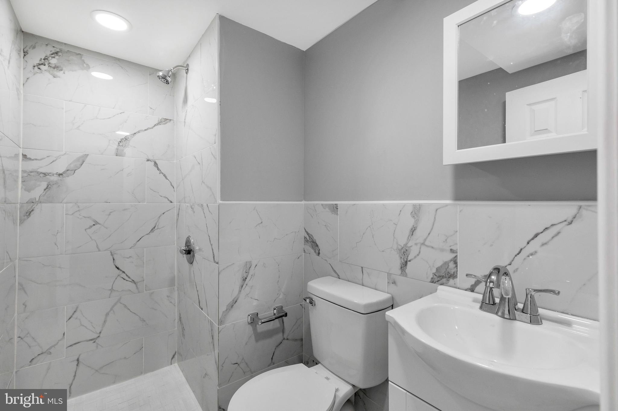 120 Englewood Road Upper Darby, PA 19082 - Photo 25 of 29 a white toilet sitting next to a bathroom sink