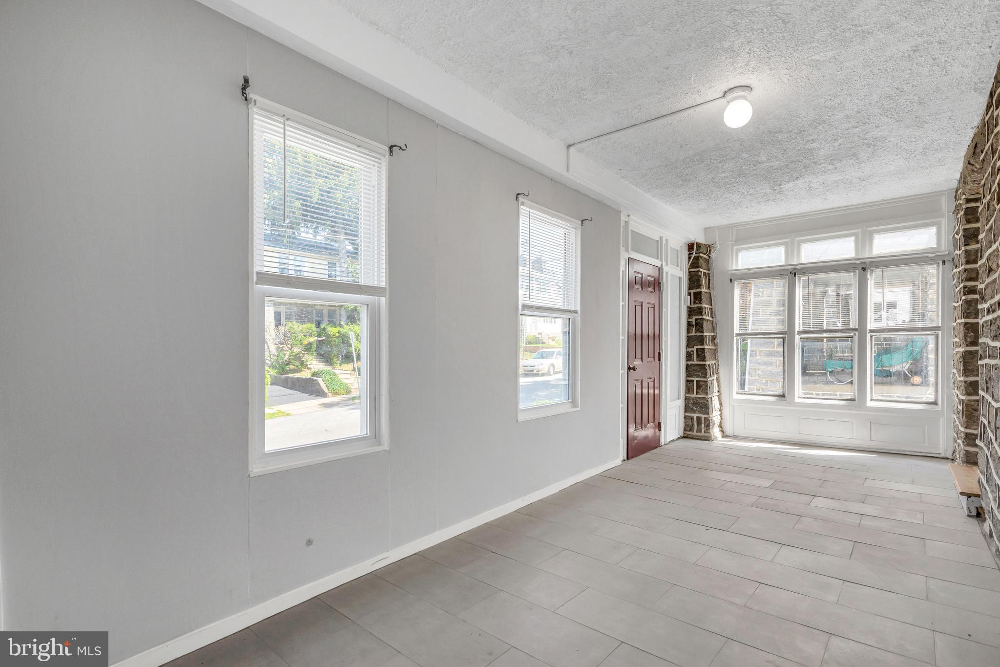 120 Englewood Road Upper Darby, PA 19082 - Photo 4 of 29 an empty room with windows and closet