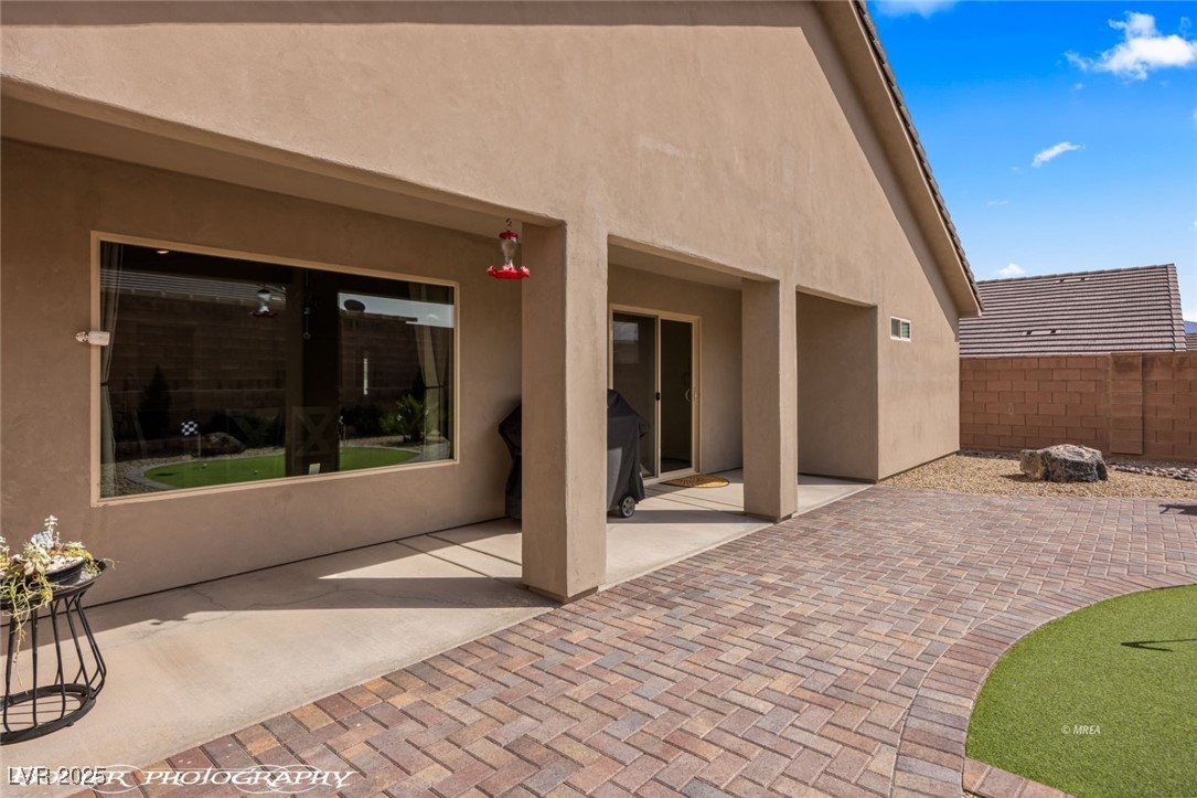 942 Shadow Hawk Ridge Mesquite, NV 89027 - Photo 48 of 67 Back of house with stucco siding, a patio area, and fence