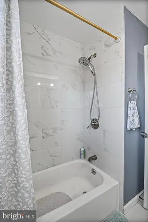 a bathroom with a bath tub with a shower